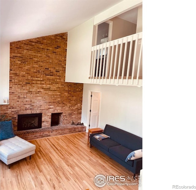 4303 30th St, Boulder, CO 80301 - living room with high vaulted ceiling, wood finished floors, and a brick fireplace