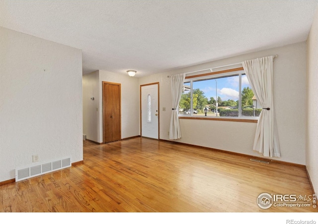 2516 Mountain View Ave, Longmont, CO 80503 - foyer featuring wood finished floors and a textured ceiling