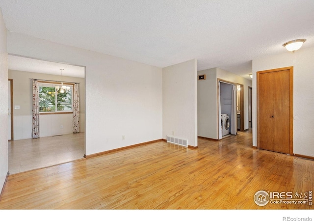 2516 Mountain View Ave, Longmont, CO 80503 - empty room with washer / dryer, light wood-style floors, and a textured ceiling