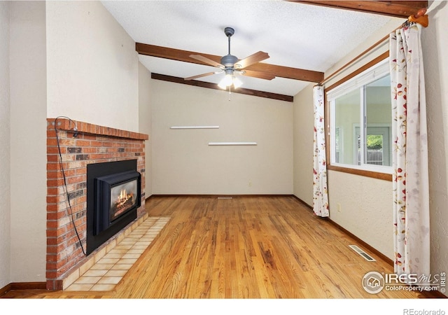 2516 Mountain View Ave, Longmont, CO 80503 - unfurnished living room with vaulted ceiling, wood finished floors, ceiling fan, and a fireplace