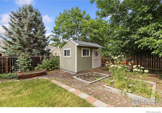 2516 Mountain View Ave, Longmont, CO 80503 - view of shed with a garden and a fenced backyard
