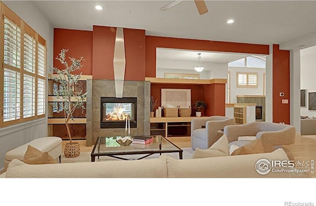 2861 Shoshone Trl, Lafayette, CO 80026 - living area with a tiled fireplace, recessed lighting, and a ceiling fan