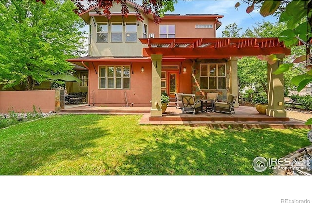2861 Shoshone Trl, Lafayette, CO 80026 - back of property featuring a lawn, stucco siding, and a patio