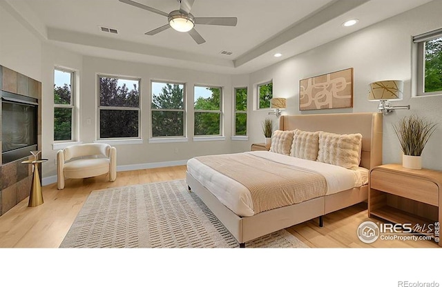 2861 Shoshone Trl, Lafayette, CO 80026 - bedroom with a tray ceiling, wood finished floors, recessed lighting, and ceiling fan
