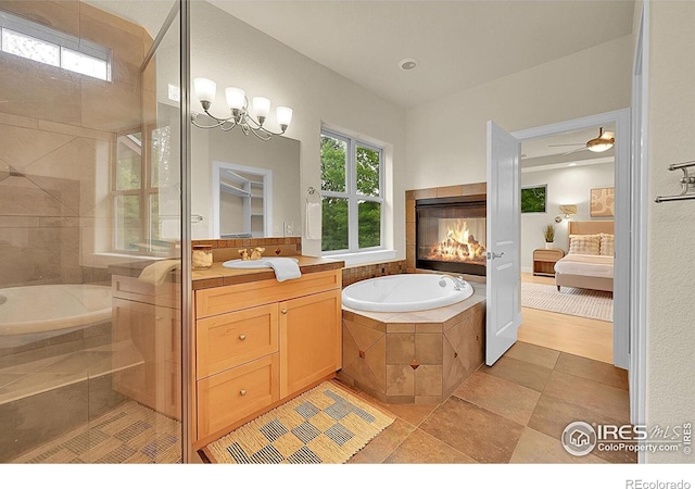 2861 Shoshone Trl, Lafayette, CO 80026 - full bath featuring ensuite bathroom, vanity, a bath, and a tiled fireplace