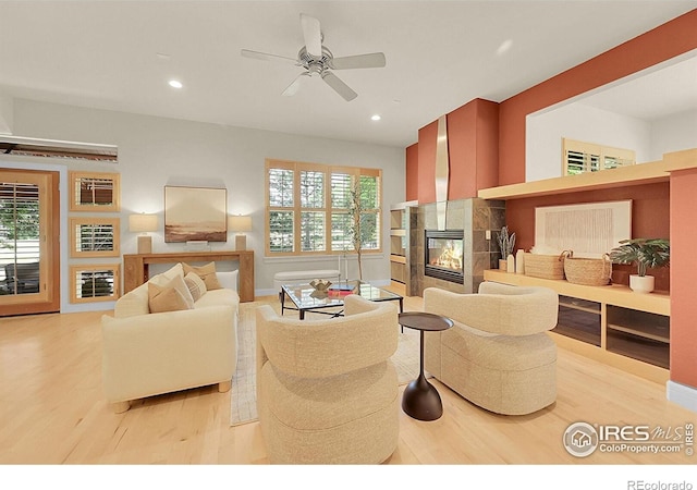 2861 Shoshone Trl, Lafayette, CO 80026 - living room with a fireplace, light wood-style floors, a ceiling fan, healthy amount of natural light, and recessed lighting