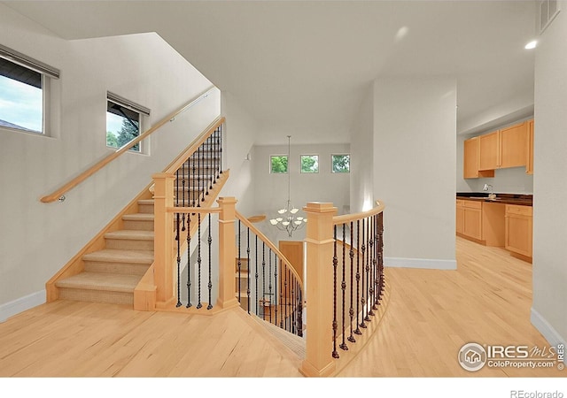 2861 Shoshone Trl, Lafayette, CO 80026 - stairway featuring wood finished floors and a chandelier