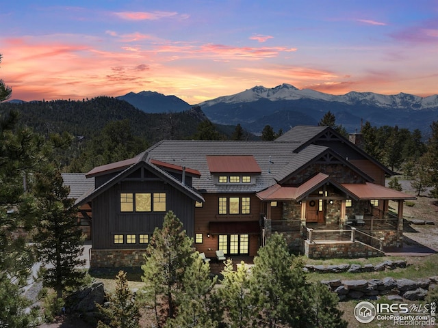 3411 Hillcrest Ln, Estes Park, CO 80517 - view of front of home with stone siding, a mountain view, board and batten siding, and covered porch