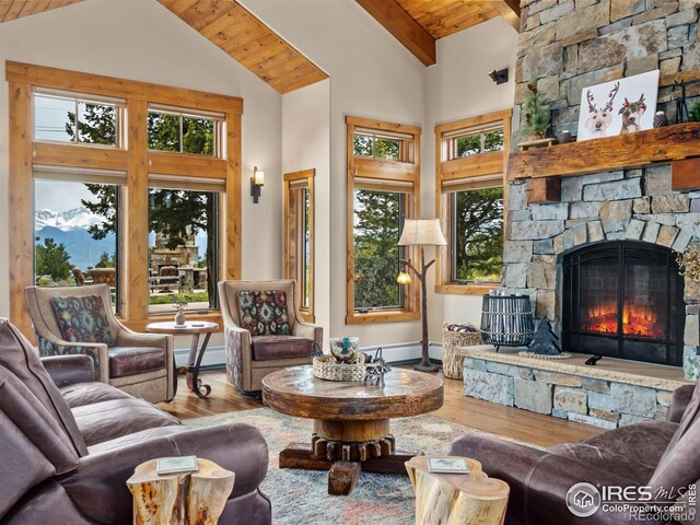 3411 Hillcrest Ln, Estes Park, CO 80517 - living area featuring a wood ceiling with exposed beams, wood finished floors, a fireplace, high vaulted ceiling, and a baseboard radiator