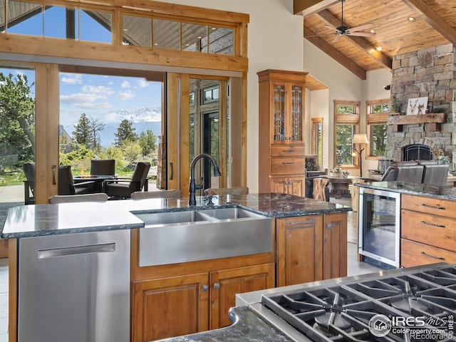 3411 Hillcrest Ln, Estes Park, CO 80517 - kitchen featuring dishwasher, wine cooler, a wood ceiling with exposed beams, brown cabinets, and open floor plan
