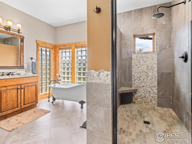 3411 Hillcrest Ln, Estes Park, CO 80517 - bathroom featuring tiled shower, a freestanding tub, tile patterned floors, and vanity