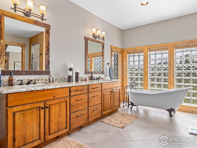 3411 Hillcrest Ln, Estes Park, CO 80517 - full bathroom featuring double vanity, a soaking tub, tile patterned flooring, and recessed lighting