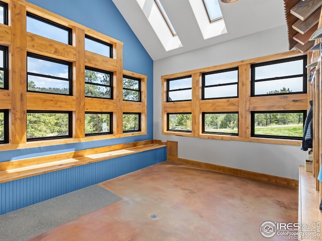 3411 Hillcrest Ln, Estes Park, CO 80517 - full bathroom featuring finished concrete flooring, a skylight, a bathtub, and high vaulted ceiling