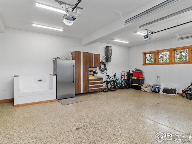 3411 Hillcrest Ln, Estes Park, CO 80517 - garage featuring freestanding refrigerator and a garage door opener