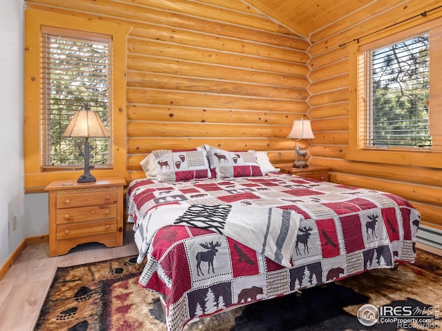 3411 Hillcrest Ln, Estes Park, CO 80517 - bedroom with multiple windows, vaulted ceiling, wood finished floors, wooden ceiling, and rustic walls