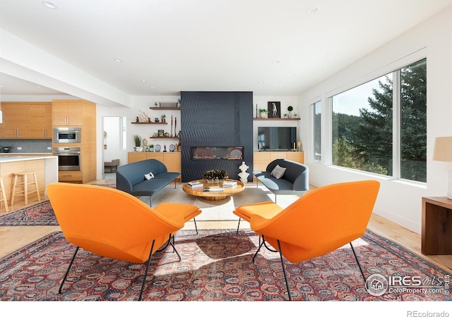 514 Granite Dr, Boulder, CO 80302 - living room with light wood-type flooring, a large fireplace, and recessed lighting