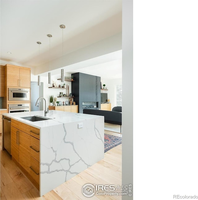 514 Granite Dr, Boulder, CO 80302 - kitchen featuring oven, dishwasher, light wood-type flooring, light stone counters, and modern cabinets