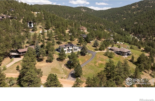 514 Granite Dr, Boulder, CO 80302 - drone / aerial view of a heavily wooded area and a mountain backdrop