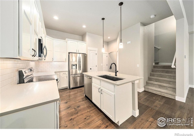 2470 Trio Falls Dr, Loveland, CO 80538 - kitchen featuring stainless steel appliances, dark wood-type flooring, backsplash, white cabinetry, and recessed lighting