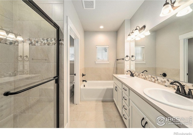 2470 Trio Falls Dr, Loveland, CO 80538 - full bathroom with double vanity, a shower stall, tile patterned flooring, recessed lighting, and a bathtub