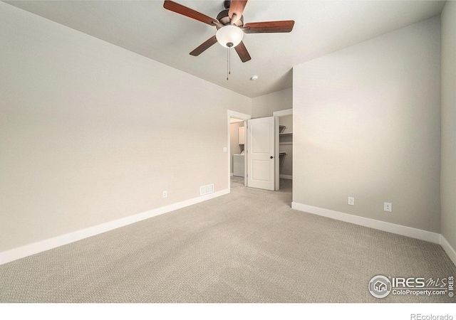 2470 Trio Falls Dr, Loveland, CO 80538 - unfurnished bedroom featuring light colored carpet, a walk in closet, and ceiling fan