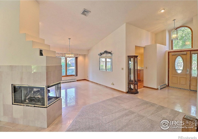 1357 43rd Ave Unit 60, Greeley, CO 80634 - foyer with a chandelier, baseboard heating, light tile patterned floors, and high vaulted ceiling