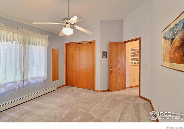 1357 43rd Ave Unit 60, Greeley, CO 80634 - unfurnished bedroom featuring carpet floors, a baseboard heating unit, a closet, a ceiling fan, and lofted ceiling