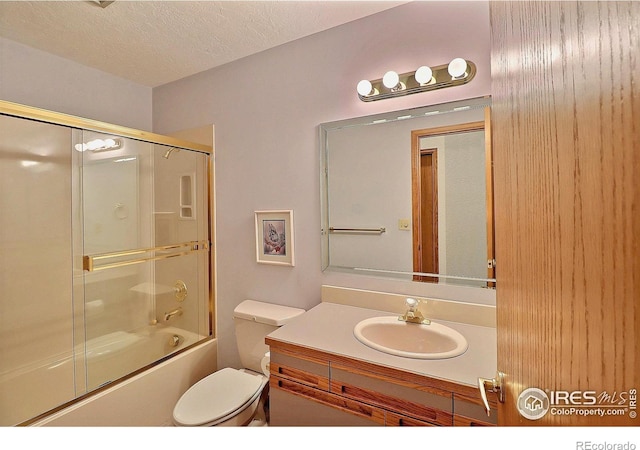 1357 43rd Ave Unit 60, Greeley, CO 80634 - bathroom with vanity, bath / shower combo with glass door, and a textured ceiling