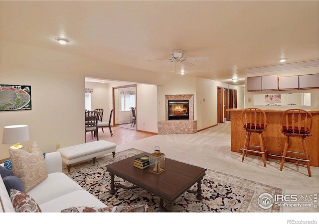 1357 43rd Ave Unit 60, Greeley, CO 80634 - living room featuring a ceiling fan, a high end fireplace, and light colored carpet