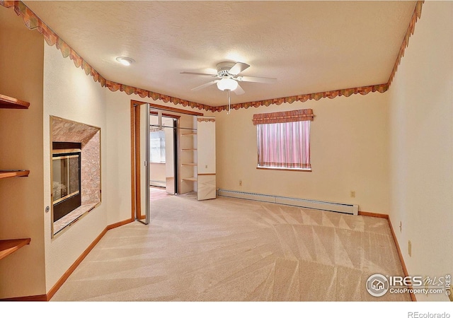 1357 43rd Ave Unit 60, Greeley, CO 80634 - carpeted spare room featuring a baseboard radiator, healthy amount of natural light, ceiling fan, a baseboard heating unit, and a textured ceiling
