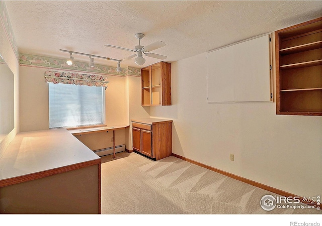 1357 43rd Ave Unit 60, Greeley, CO 80634 - kitchen with a baseboard heating unit, open shelves, a ceiling fan, a textured ceiling, and light carpet
