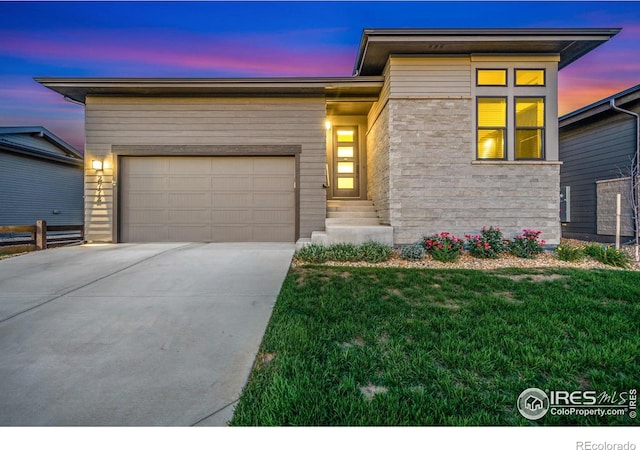 2772 Vallecito St, Timnath, CO 80547 - view of front facade with driveway, a garage, a front yard, and stone siding