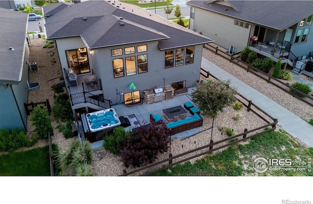 2772 Vallecito St, Timnath, CO 80547 - rear view of property featuring a fire pit, a patio, roof with shingles, and a vegetable garden