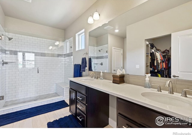 2772 Vallecito St, Timnath, CO 80547 - bathroom featuring a stall shower, double vanity, a spacious closet, and tile patterned floors