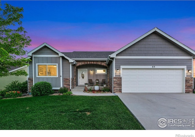 83 Evans St, Severance, CO 80550 - ranch-style house featuring stone siding, a front yard, an attached garage, driveway, and board and batten siding