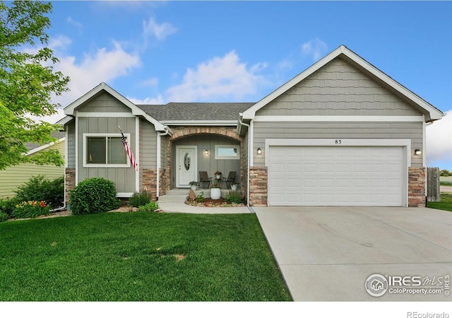 83 Evans St, Severance, CO 80550 - view of front of home featuring stone siding, a front lawn, an attached garage, board and batten siding, and concrete driveway