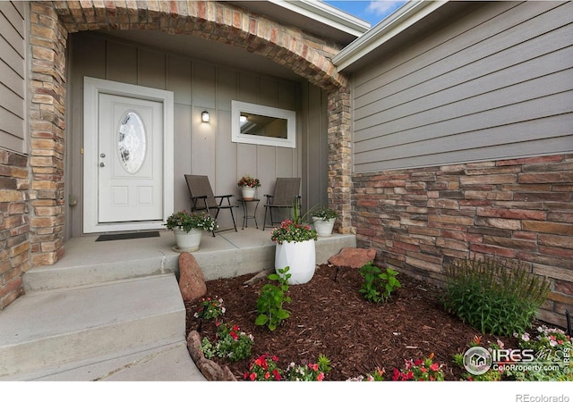 83 Evans St, Severance, CO 80550 - property entrance featuring a porch, board and batten siding, and stone siding