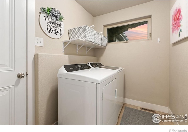 83 Evans St, Severance, CO 80550 - laundry room with independent washer and dryer and tile patterned flooring