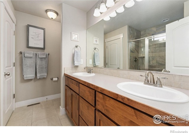 83 Evans St, Severance, CO 80550 - bathroom with a stall shower, double vanity, and tile patterned flooring