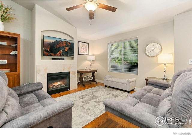 83 Evans St, Severance, CO 80550 - living room with ceiling fan, wood finished floors, lofted ceiling, and a tiled fireplace