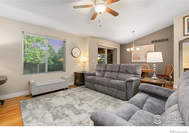 83 Evans St, Severance, CO 80550 - living room with vaulted ceiling, plenty of natural light, a ceiling fan, wood finished floors, and a chandelier