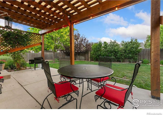 83 Evans St, Severance, CO 80550 - fenced backyard featuring a pergola, outdoor dining space, and a patio