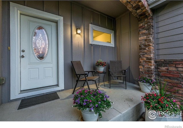 83 Evans St, Severance, CO 80550 - view of exterior entry with board and batten siding, covered porch, and stone siding