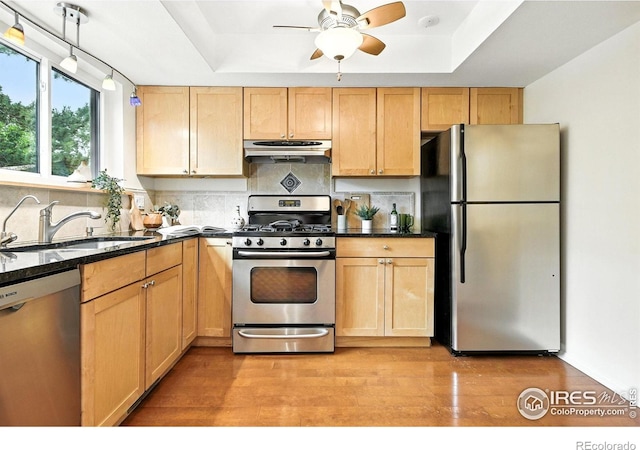 770 Quince Cir, Boulder, CO 80304 - kitchen with appliances with stainless steel finishes, under cabinet range hood, decorative backsplash, and a raised ceiling