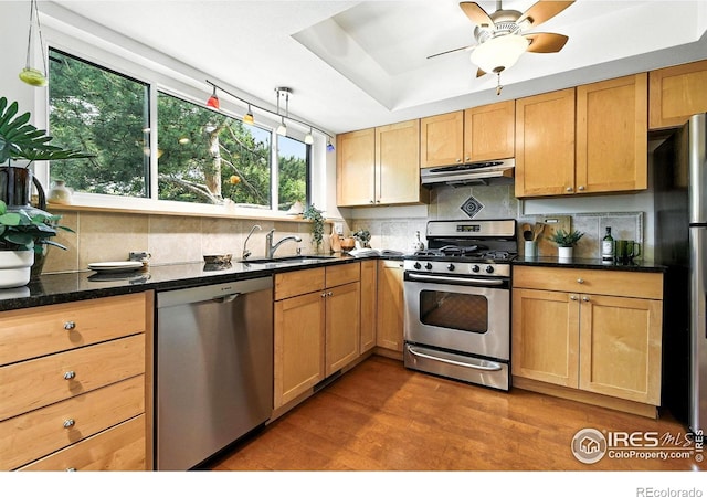 770 Quince Cir, Boulder, CO 80304 - kitchen featuring stainless steel appliances, exhaust hood, wood finished floors, and backsplash