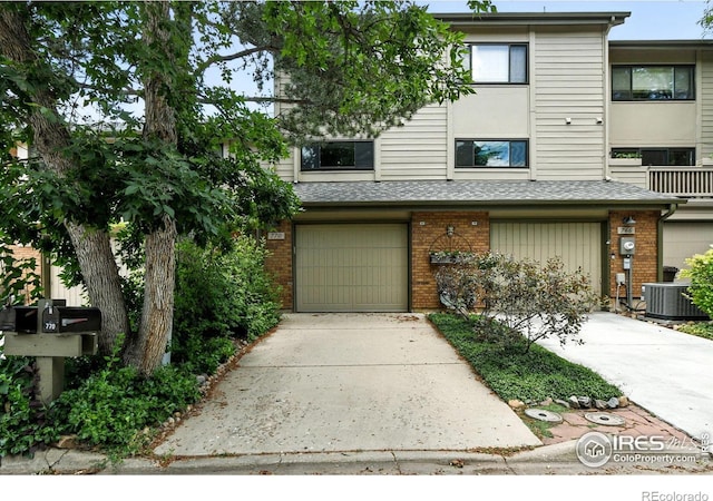 770 Quince Cir, Boulder, CO 80304 - townhome / multi-family property with brick siding, concrete driveway, and an attached garage