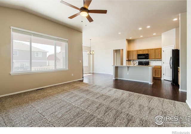 10400 17th St, Greeley, CO 80634 - kitchen featuring black appliances, a chandelier, open floor plan, light countertops, and ceiling fan