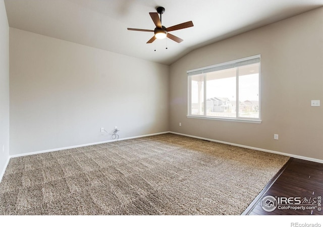 10400 17th St, Greeley, CO 80634 - unfurnished room featuring vaulted ceiling, a ceiling fan, carpet flooring, and wood finished floors