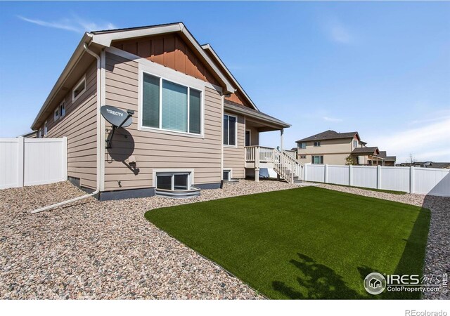 10400 17th St, Greeley, CO 80634 - rear view of property with a fenced backyard and board and batten siding