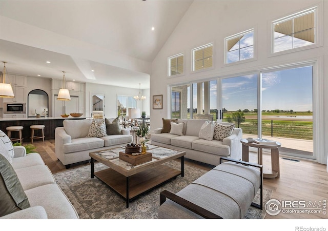 2568 Southwind Rd, Berthoud, CO 80513 - living area featuring light wood-type flooring, high vaulted ceiling, a chandelier, and recessed lighting
